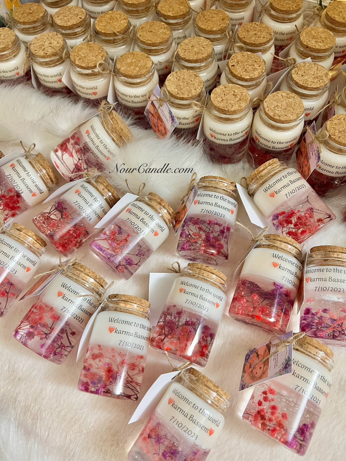 Glass candles with dried roses