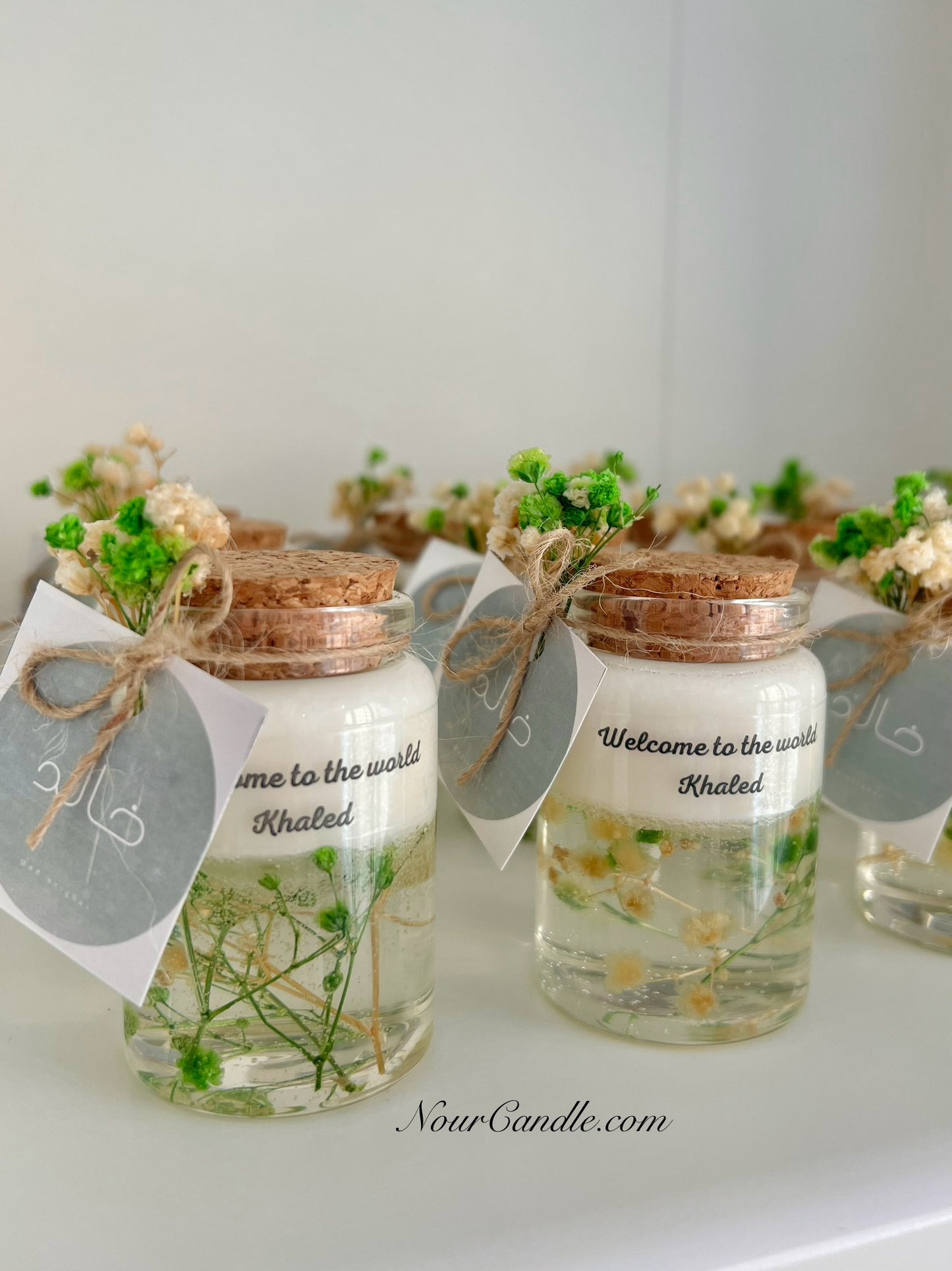 Glass candles with dried roses