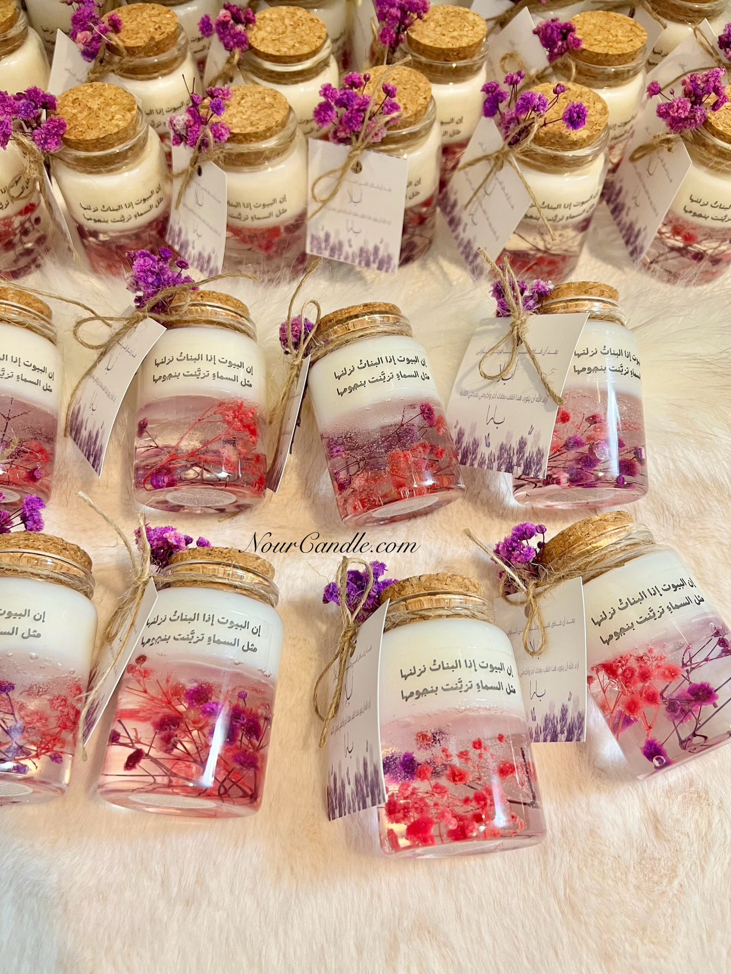 Glass candles with dried roses