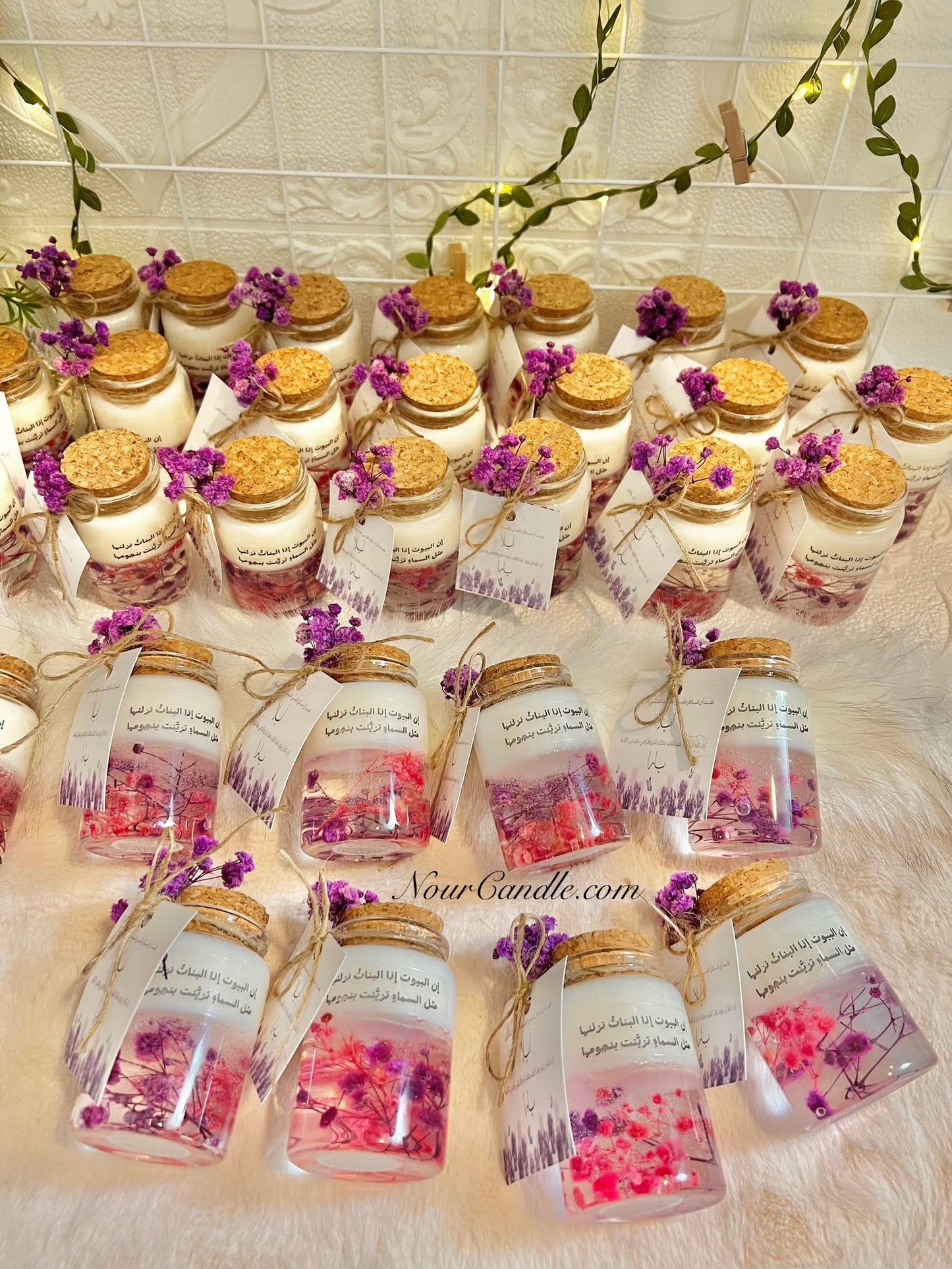 Glass candles with dried roses