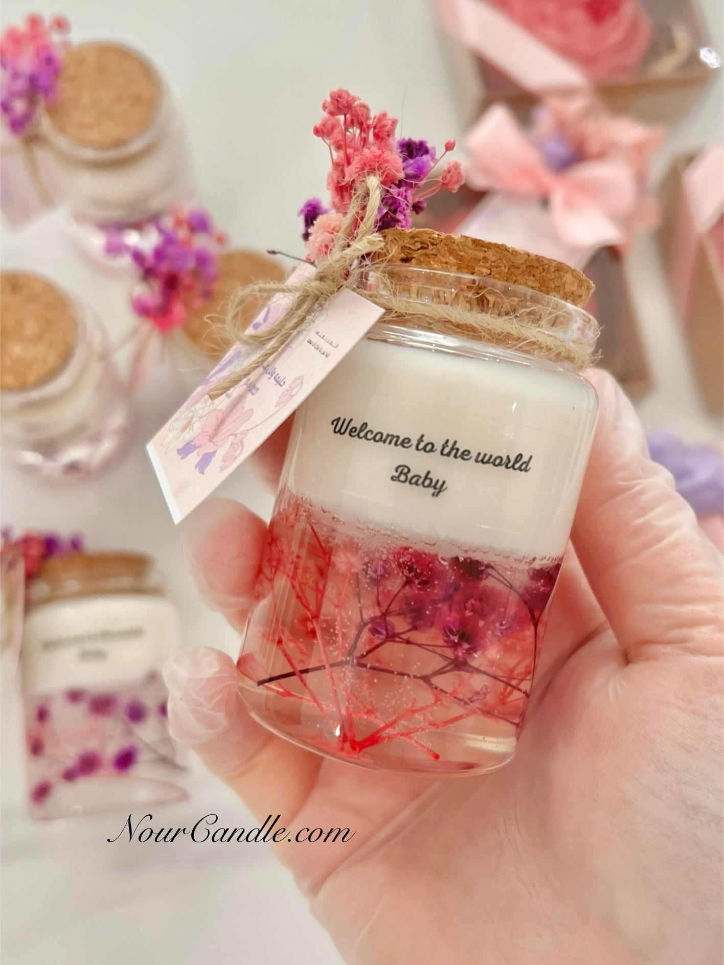 Glass candles with dried roses